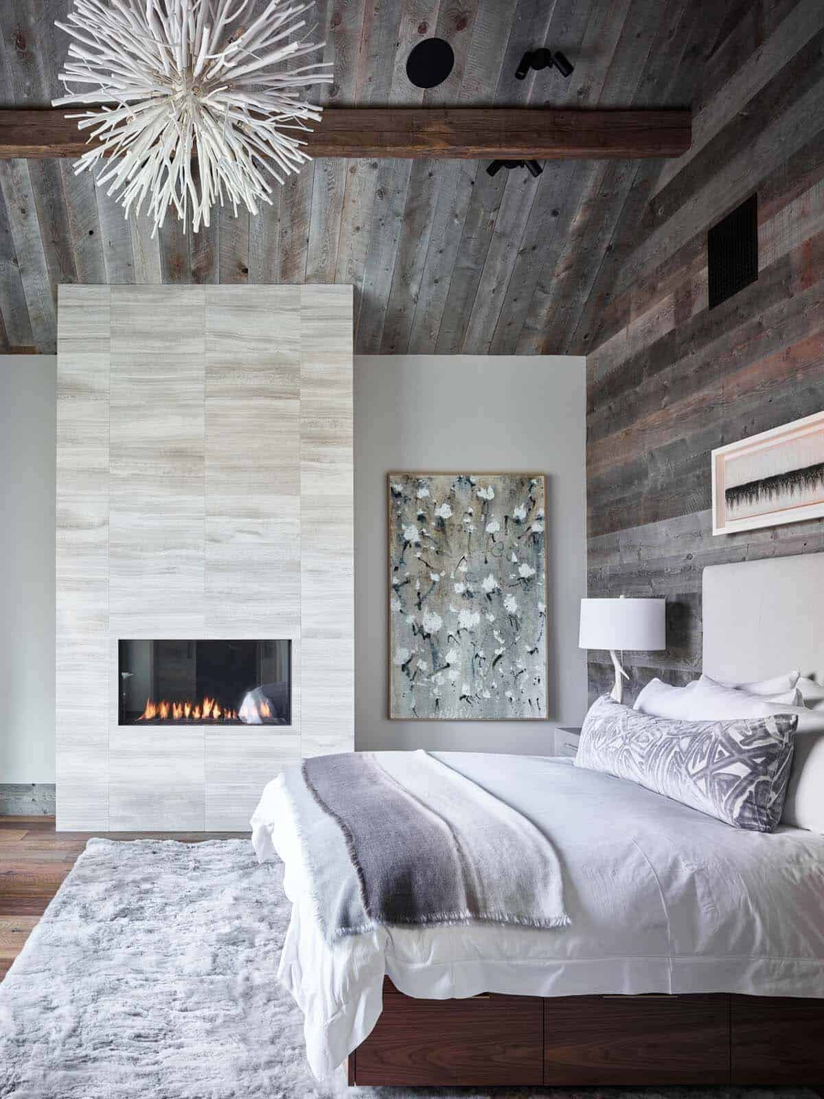 rustic modern mountain style bedroom with a fireplace
