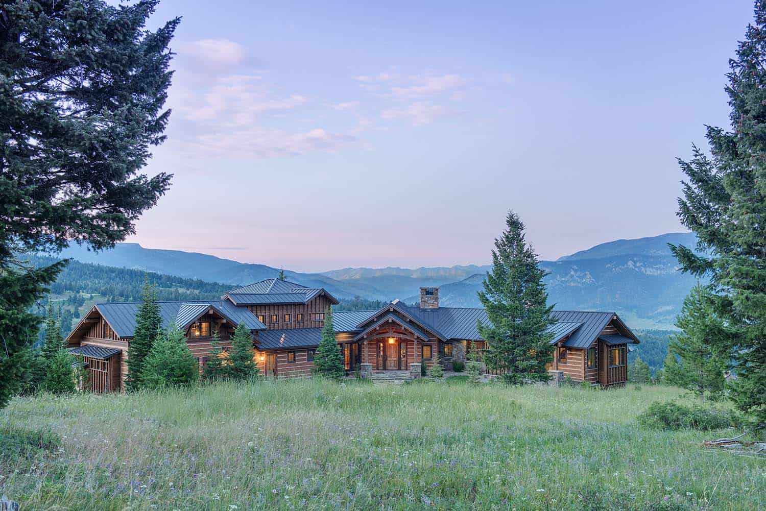 rustic timber frame mountain home exterior at dusk