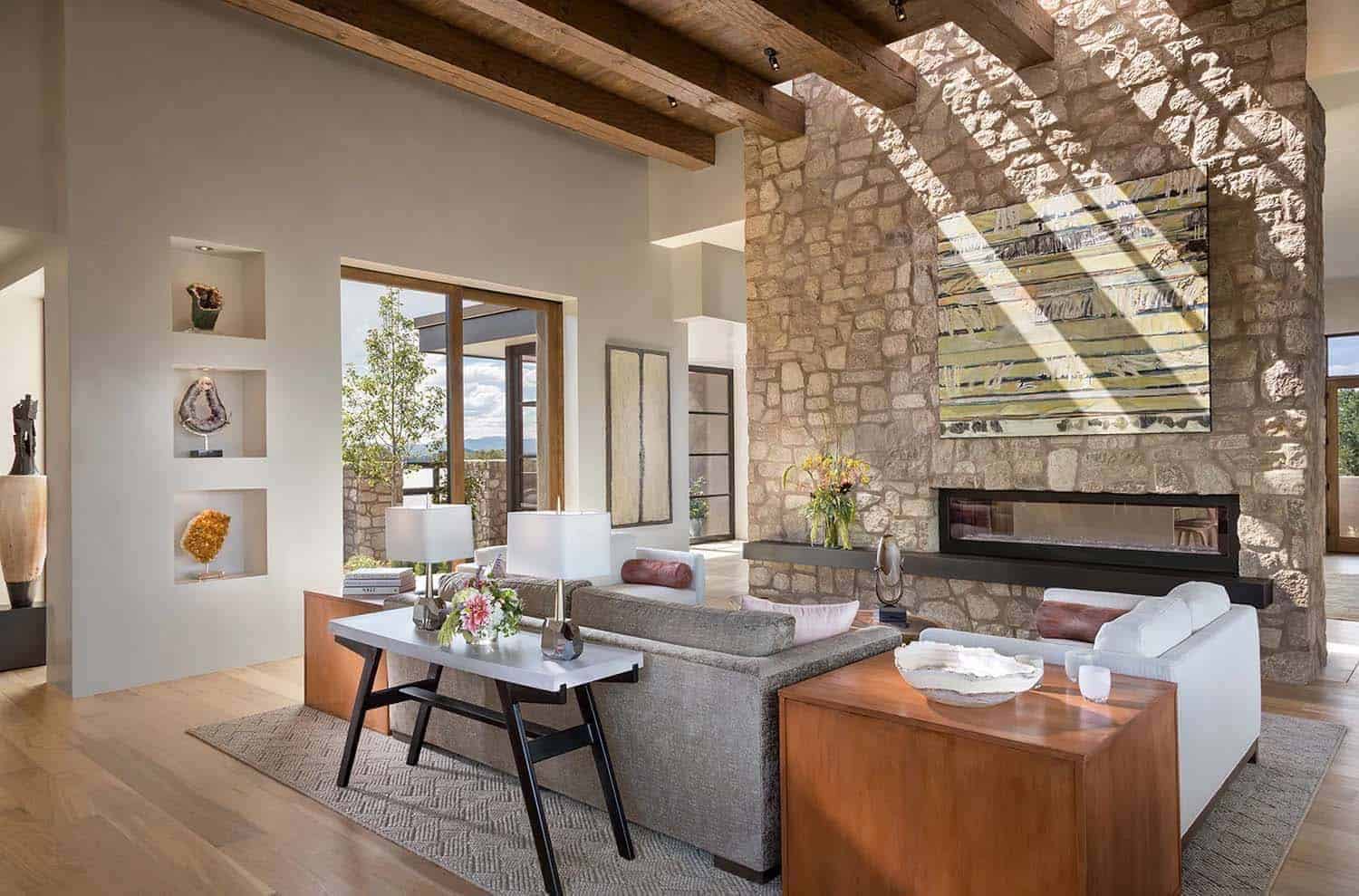 Santa Fe style living room with a stone fireplace