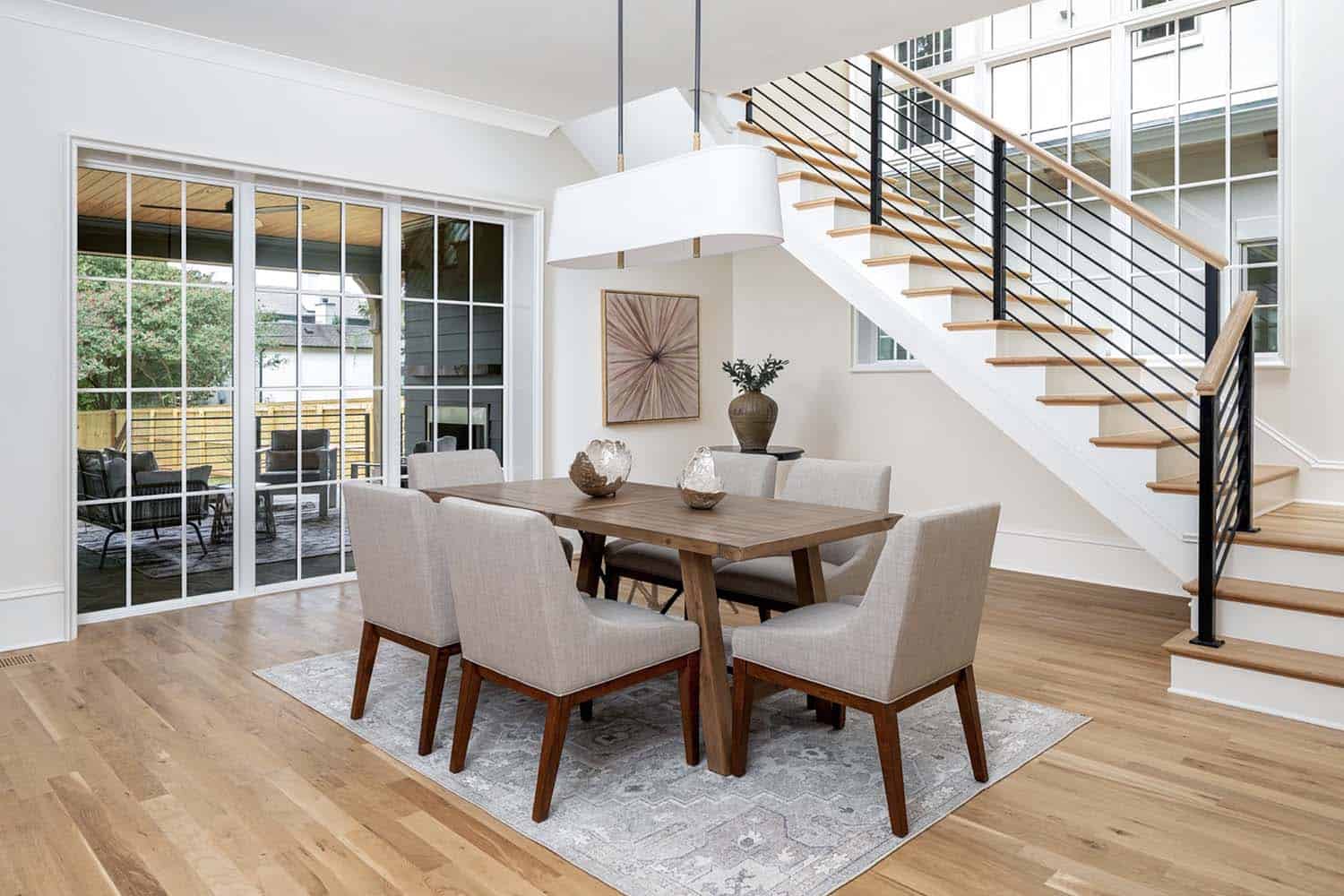 contemporary dining room with a staircase 