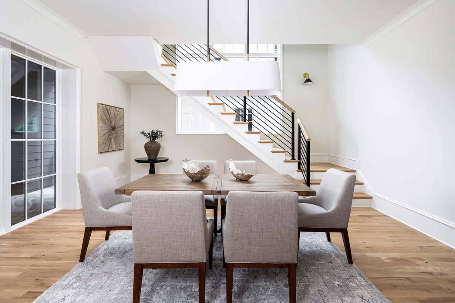 contemporary dining room with a staircase 