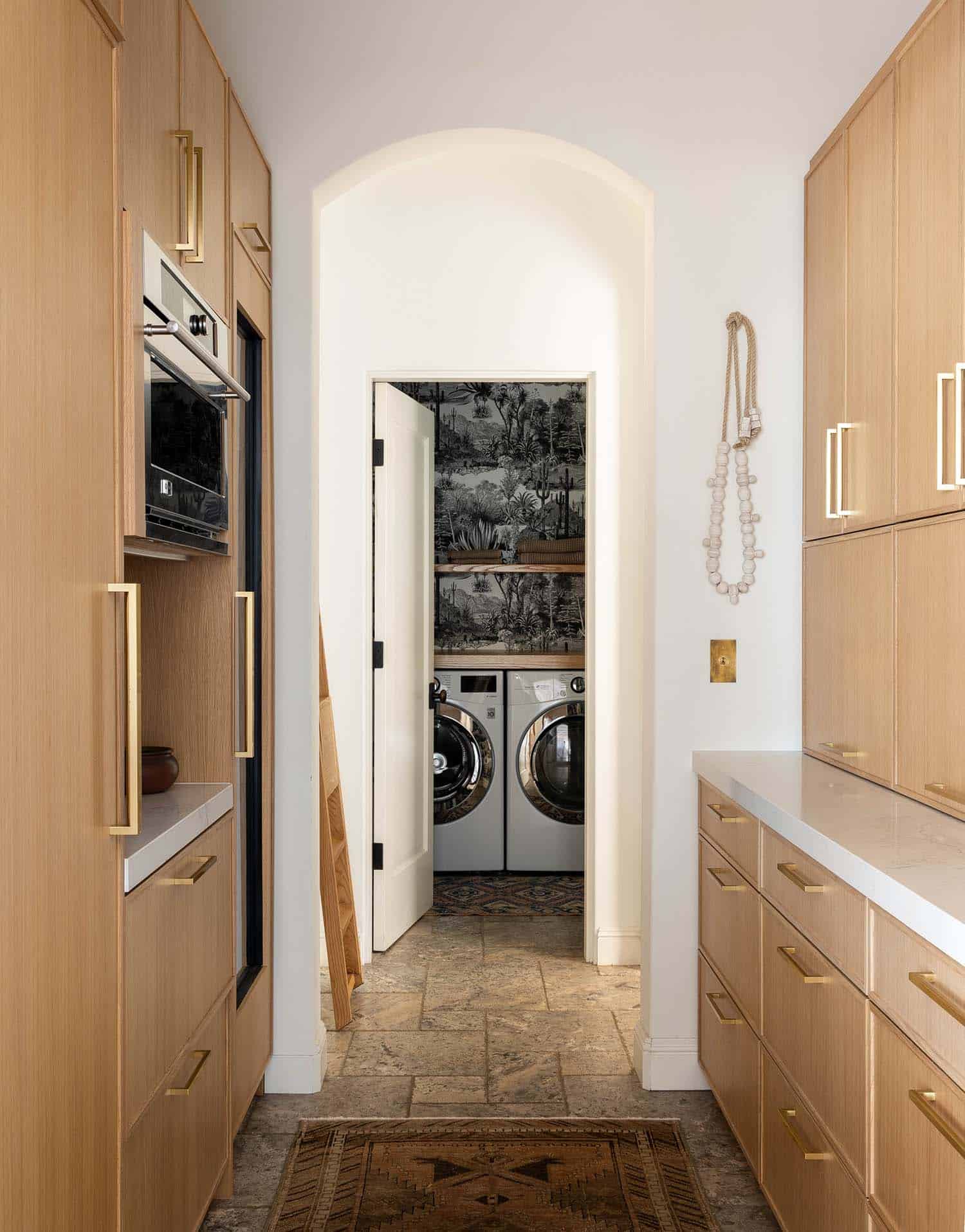 spanish colonial inspired kitchen pantry leading to the laundry room