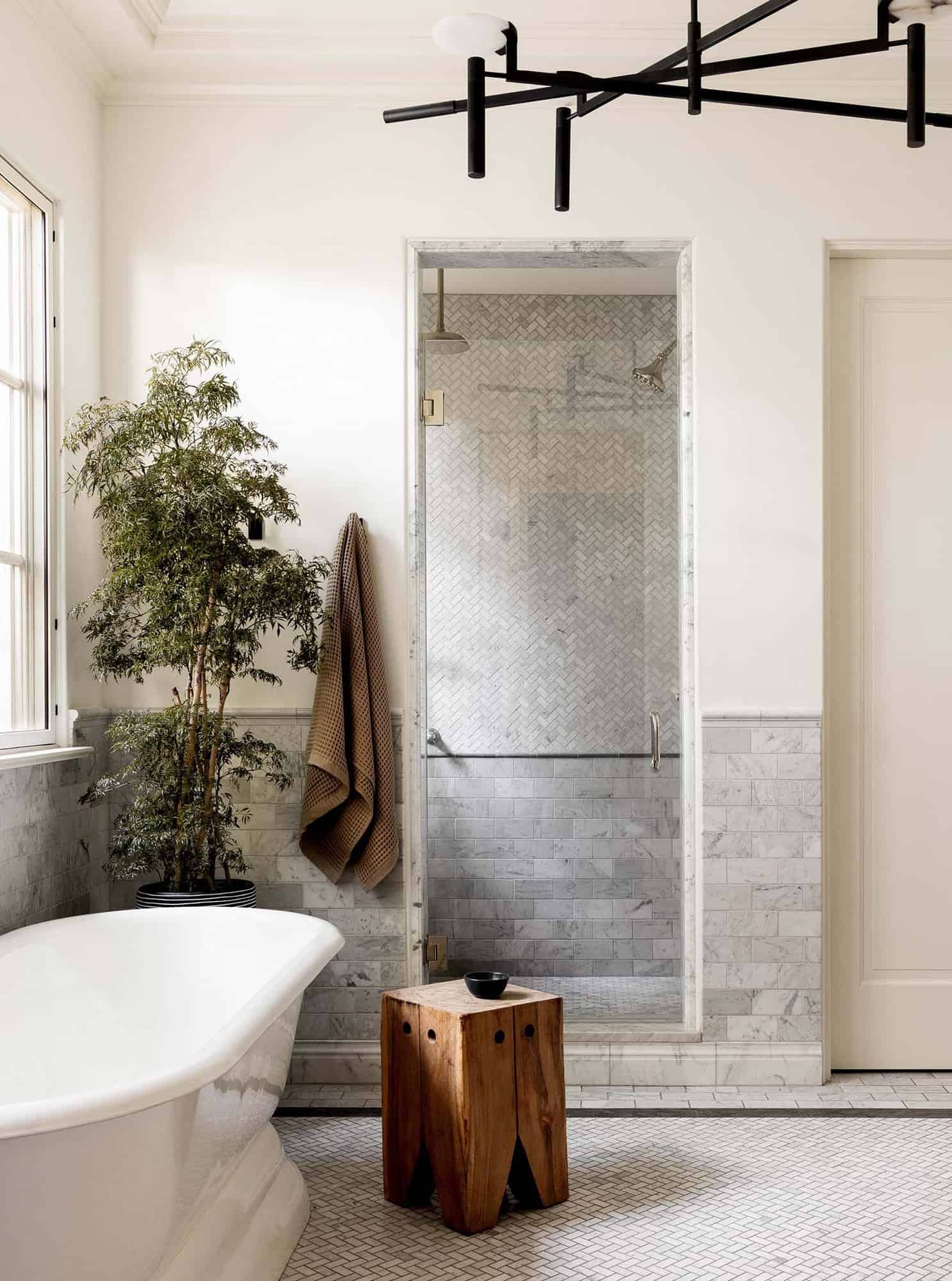 spanish colonial inspired bathroom with a freestanding tub and shower