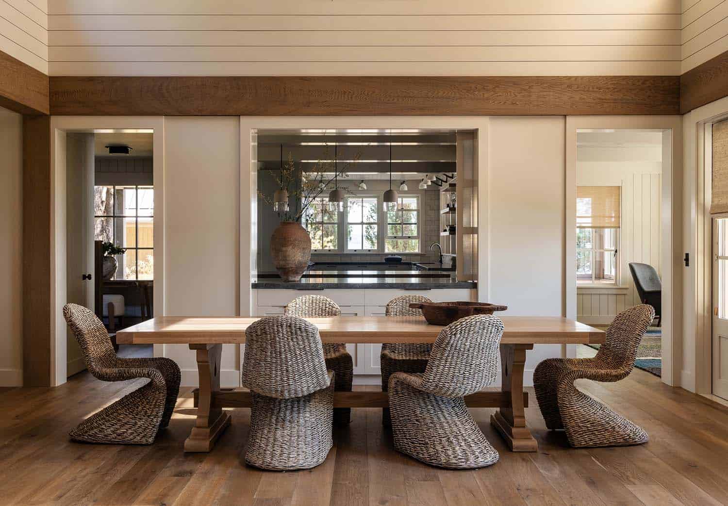 beach style dining room with pass-through window access into the kitchen