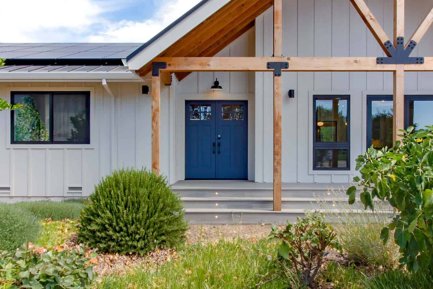 traditional farmhouse style home exterior with a blue front door