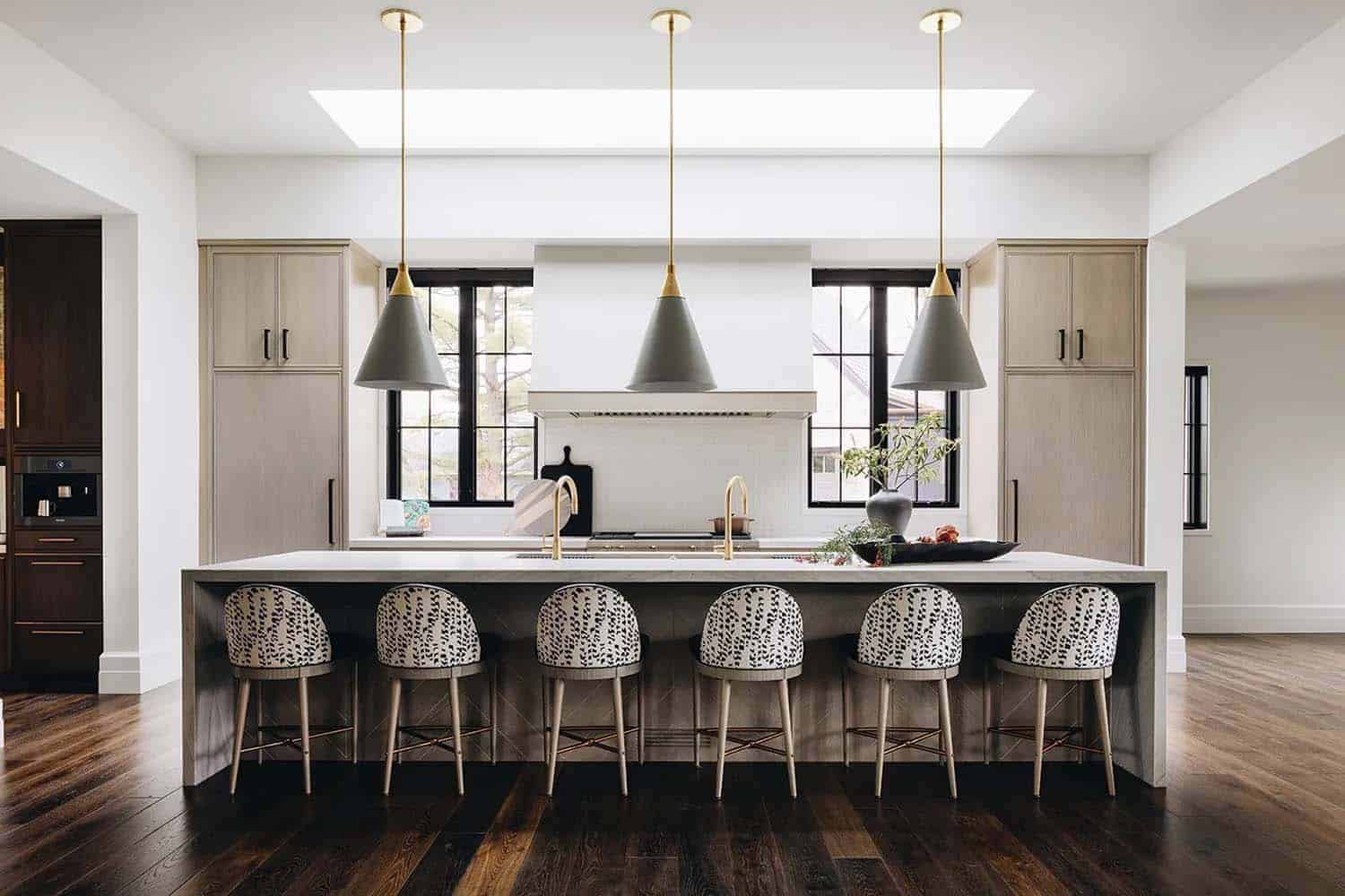 transitional style kitchen with a large island and pendant lights