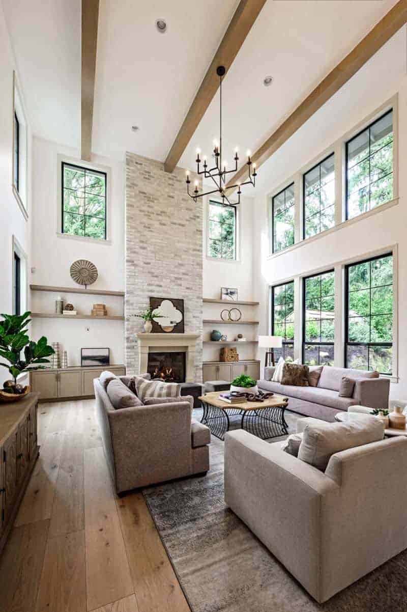 transitional style living room with two-story ceilings and wood beams