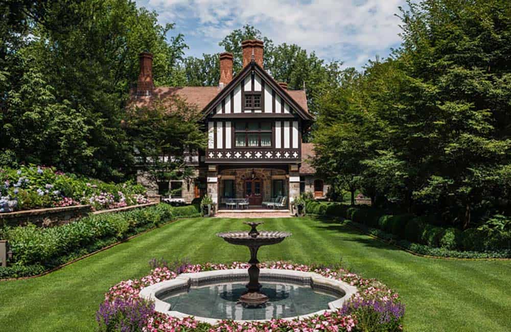 tudor style home exterior with a water feature