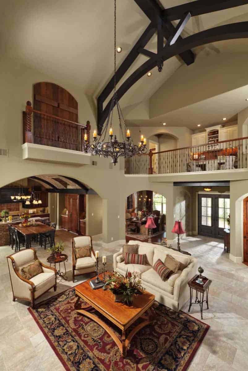 Tuscan style living room with a two-story ceiling