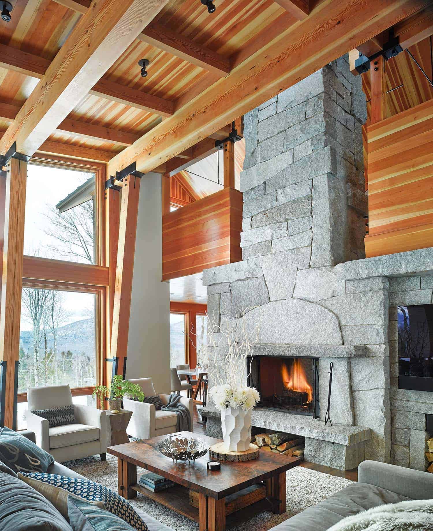 mountain style living room with a stone fireplace