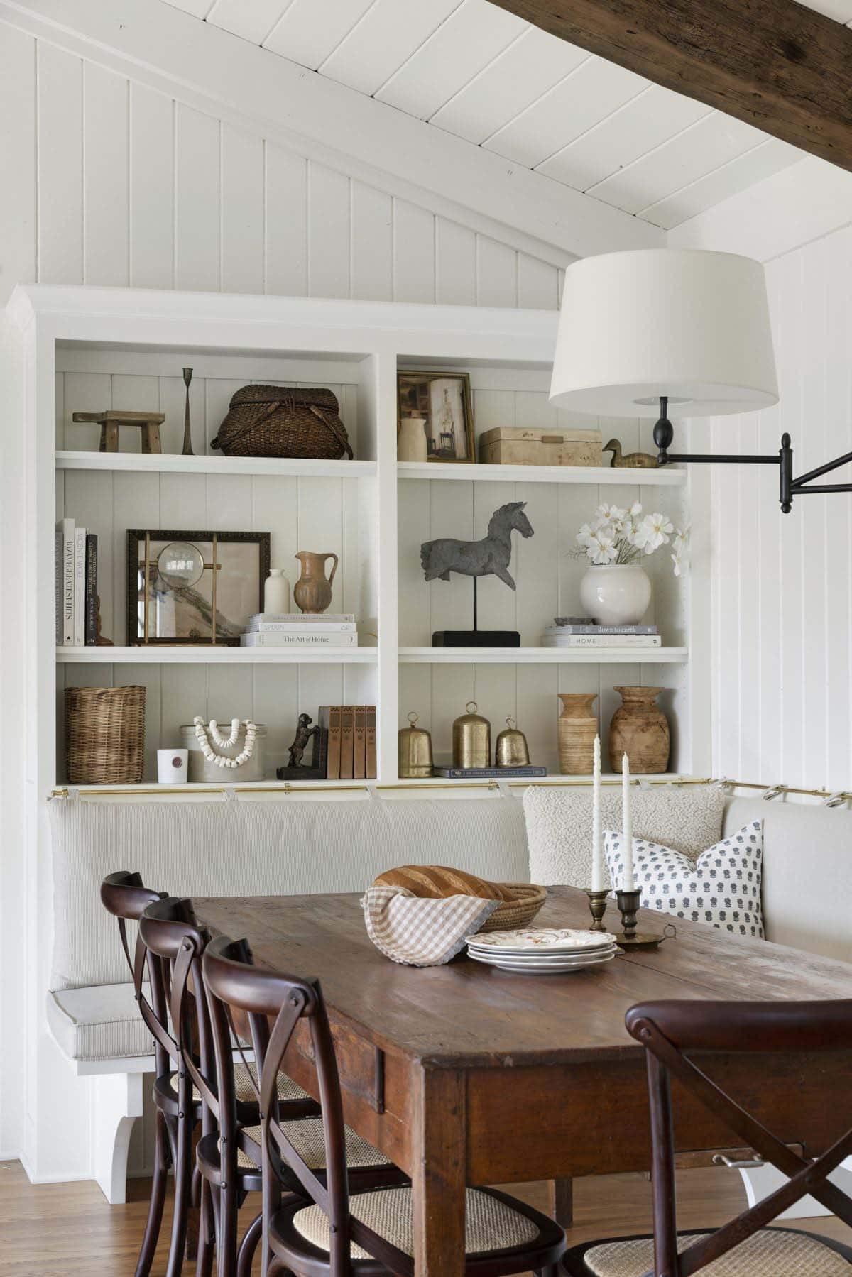 transitional dining room with built-in bookshelves