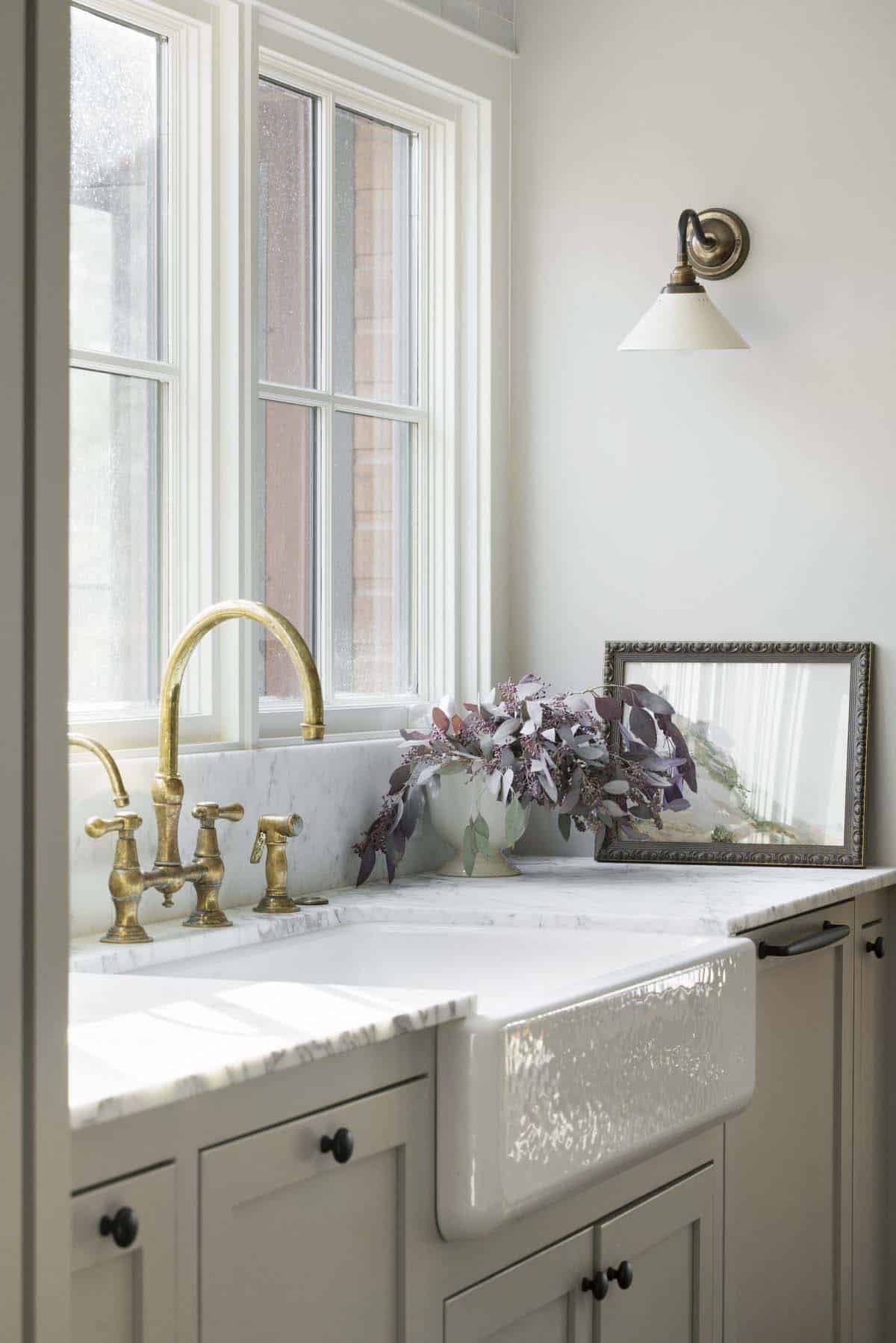 transitional kitchen sink wall with a window