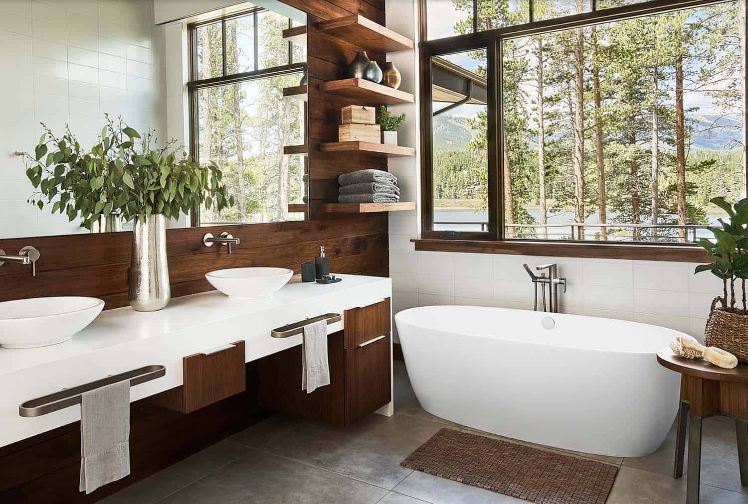 mountain modern rustic bathroom with a vanity, floating shelves and freestanding tub