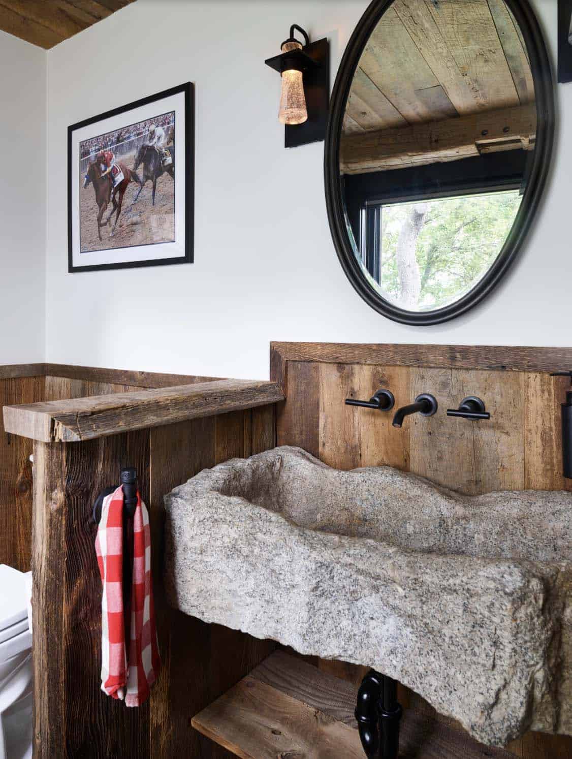 rustic bathroom with a large stone vessel sink