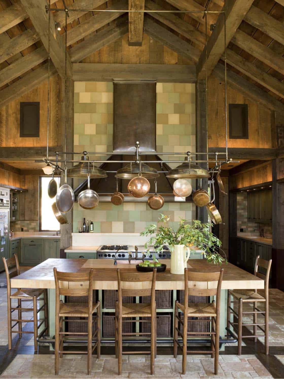 rustic kitchen with a hanging pot rack and light fixture