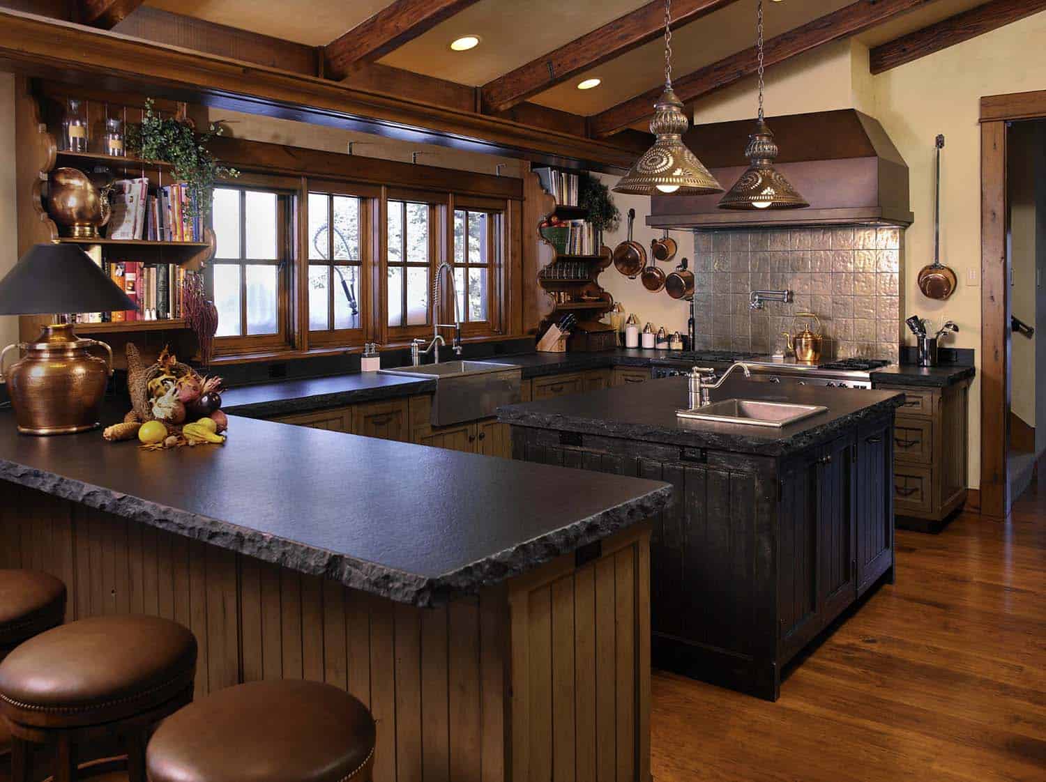 bold and rustic kitchen with soapstone countertops and tin backsplash