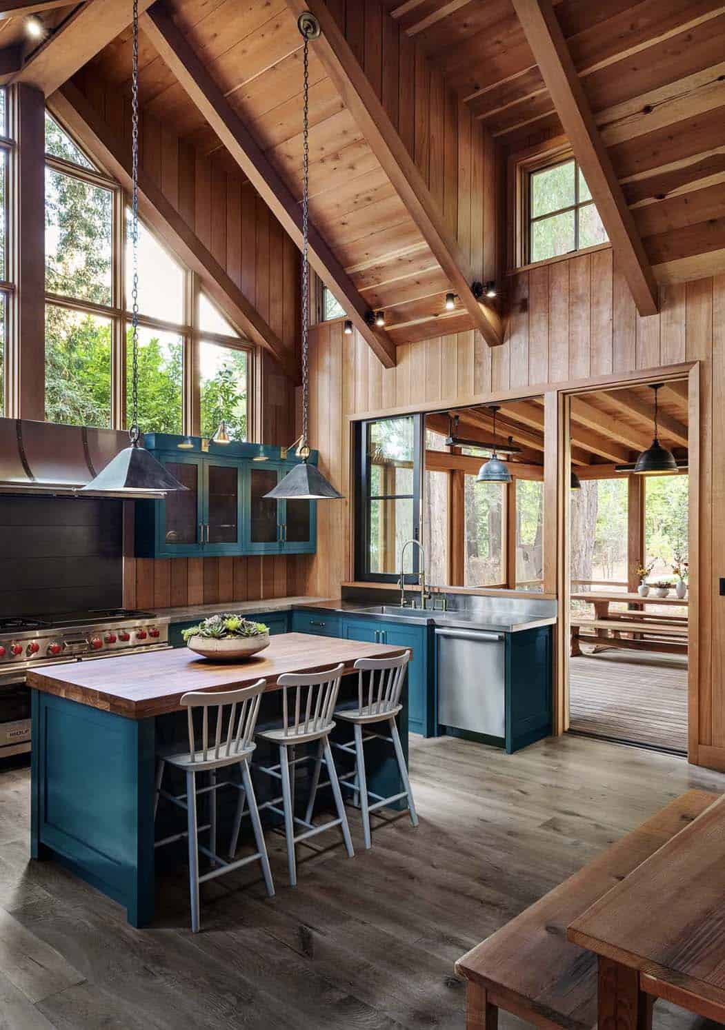 rustic kitchen with vaulted ceiling and blue cabinets
