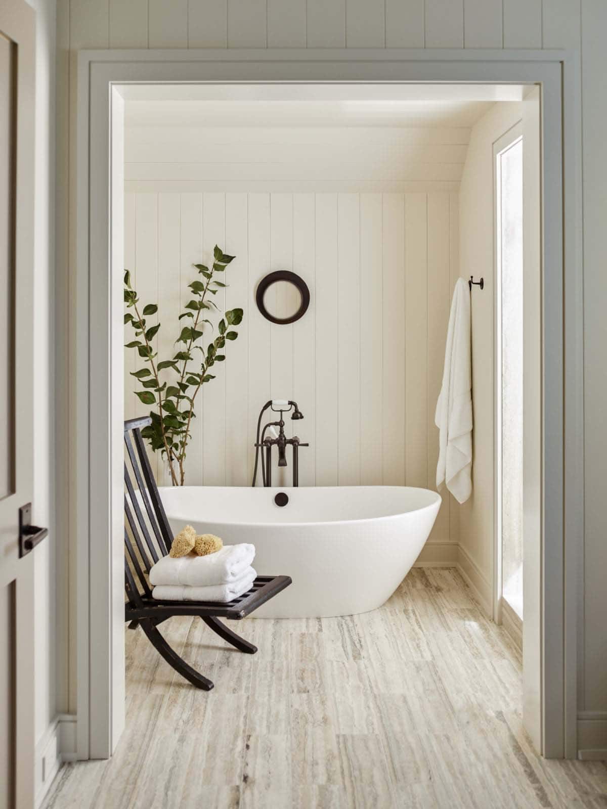 contemporary coastal style bathroom with a freestanding tub
