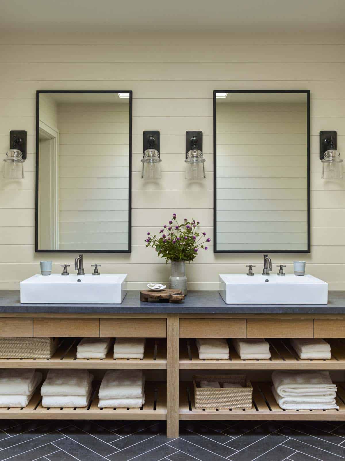 contemporary coastal style bathroom with dual sinks and mirrors