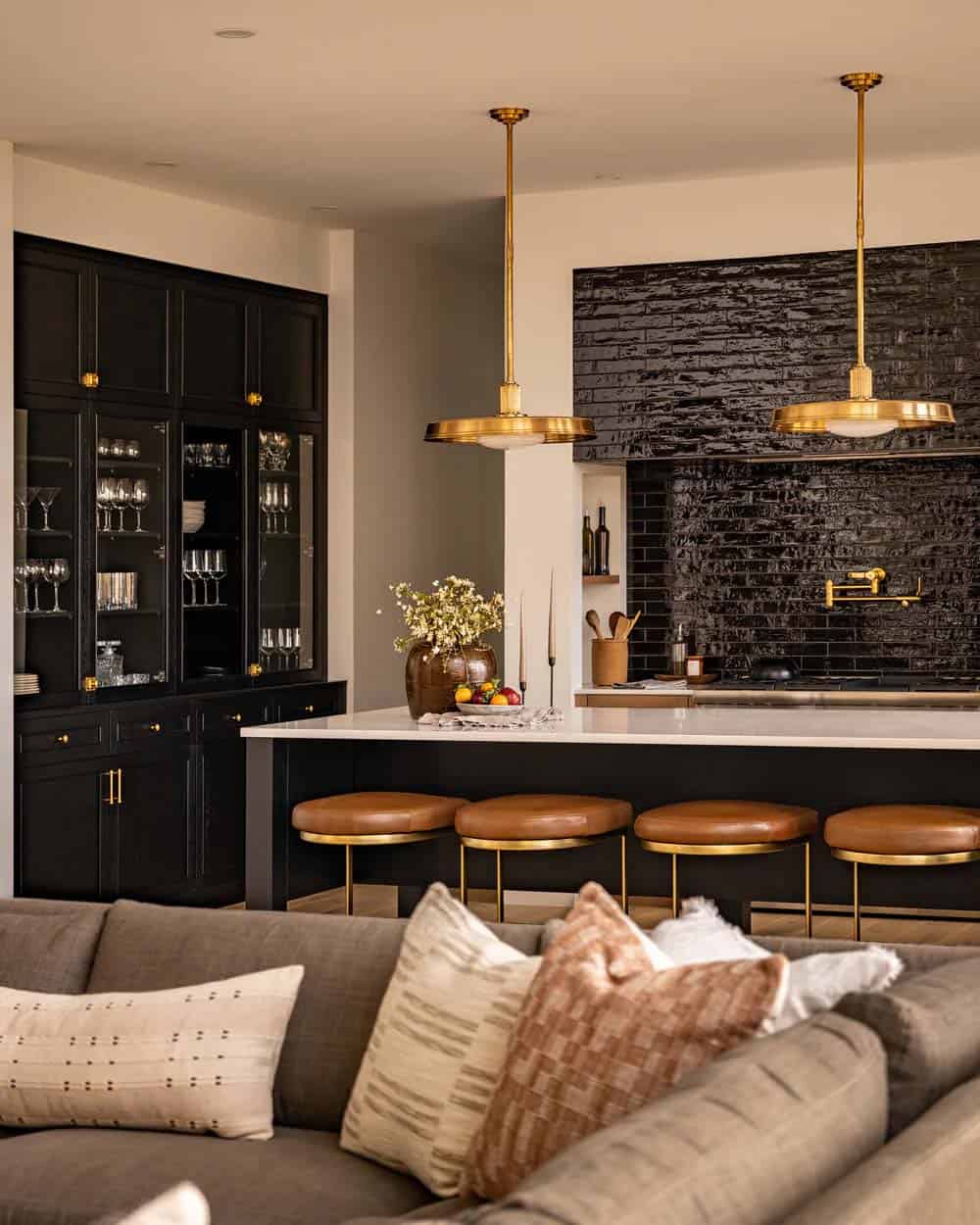 contemporary kitchen with a large island and black backsplash tile