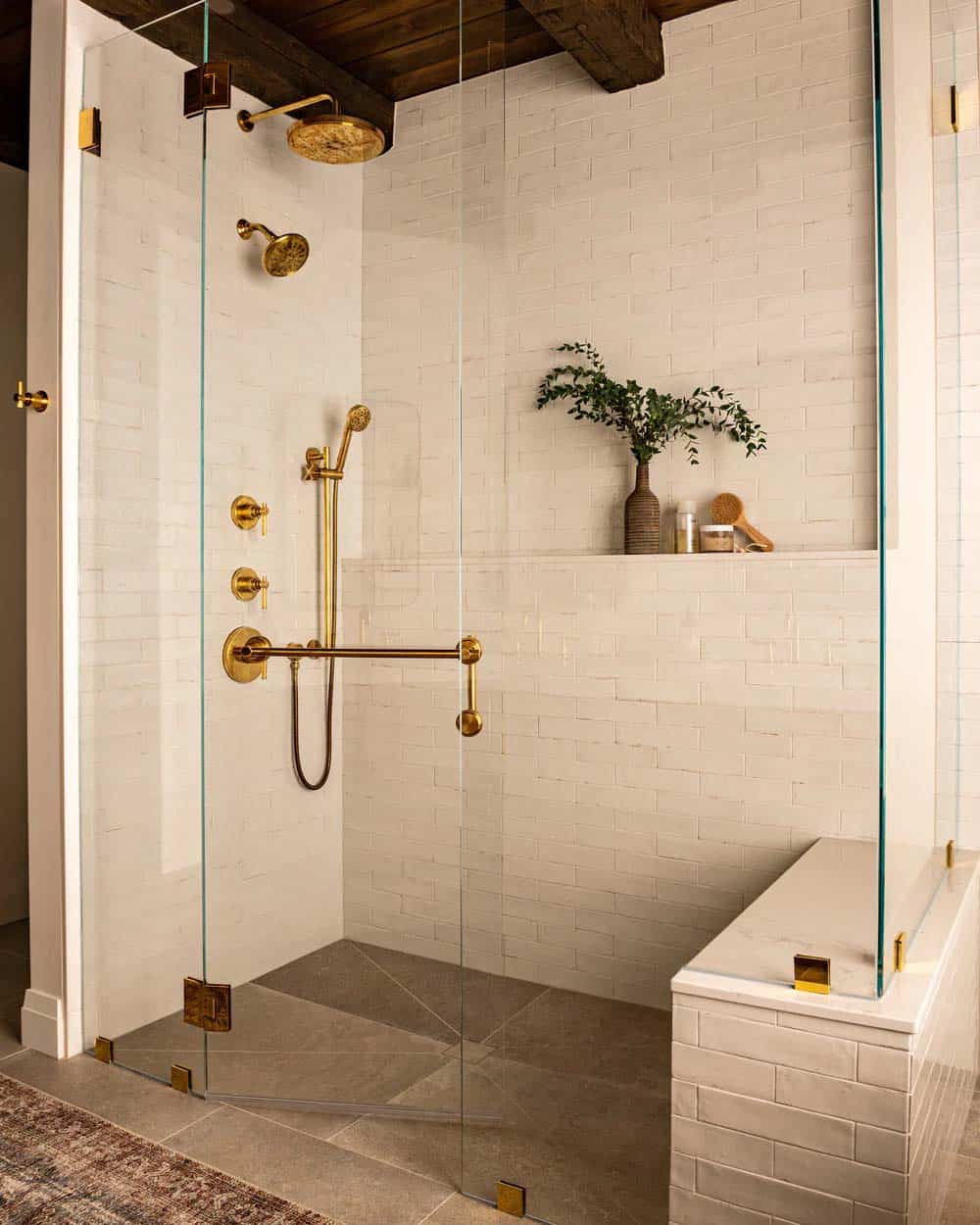 contemporary bathroom with a glass-enclosed shower and white tiles and built-in bench