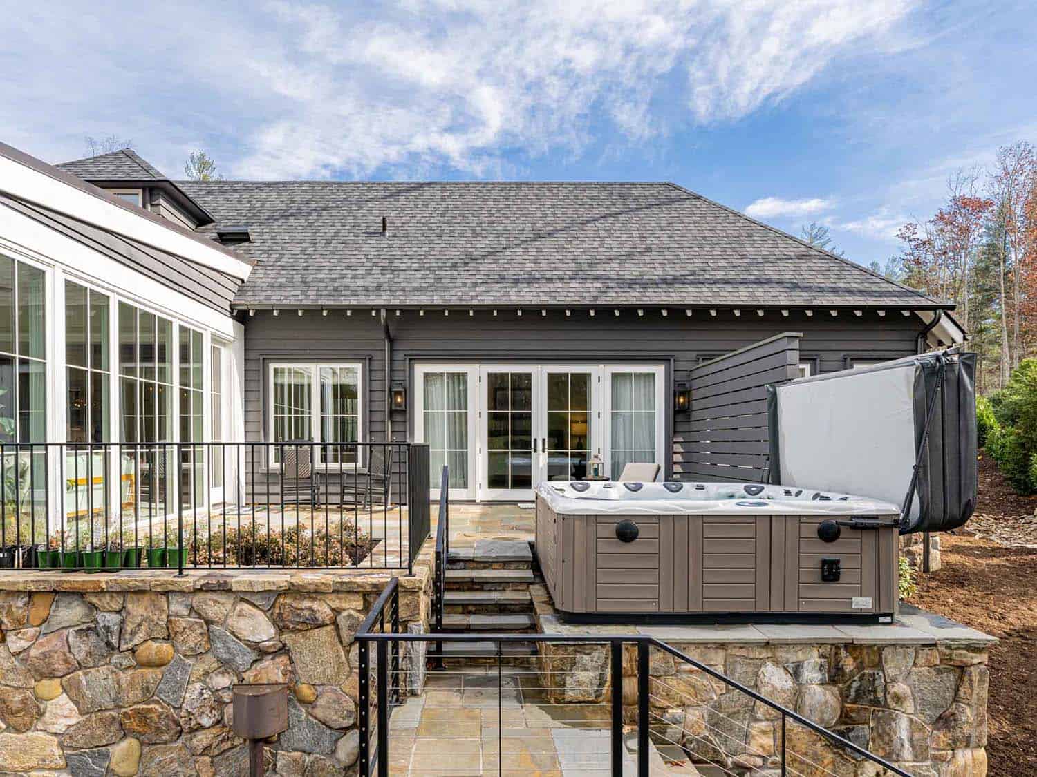 contemporary farmhouse style home patio with a hot tub