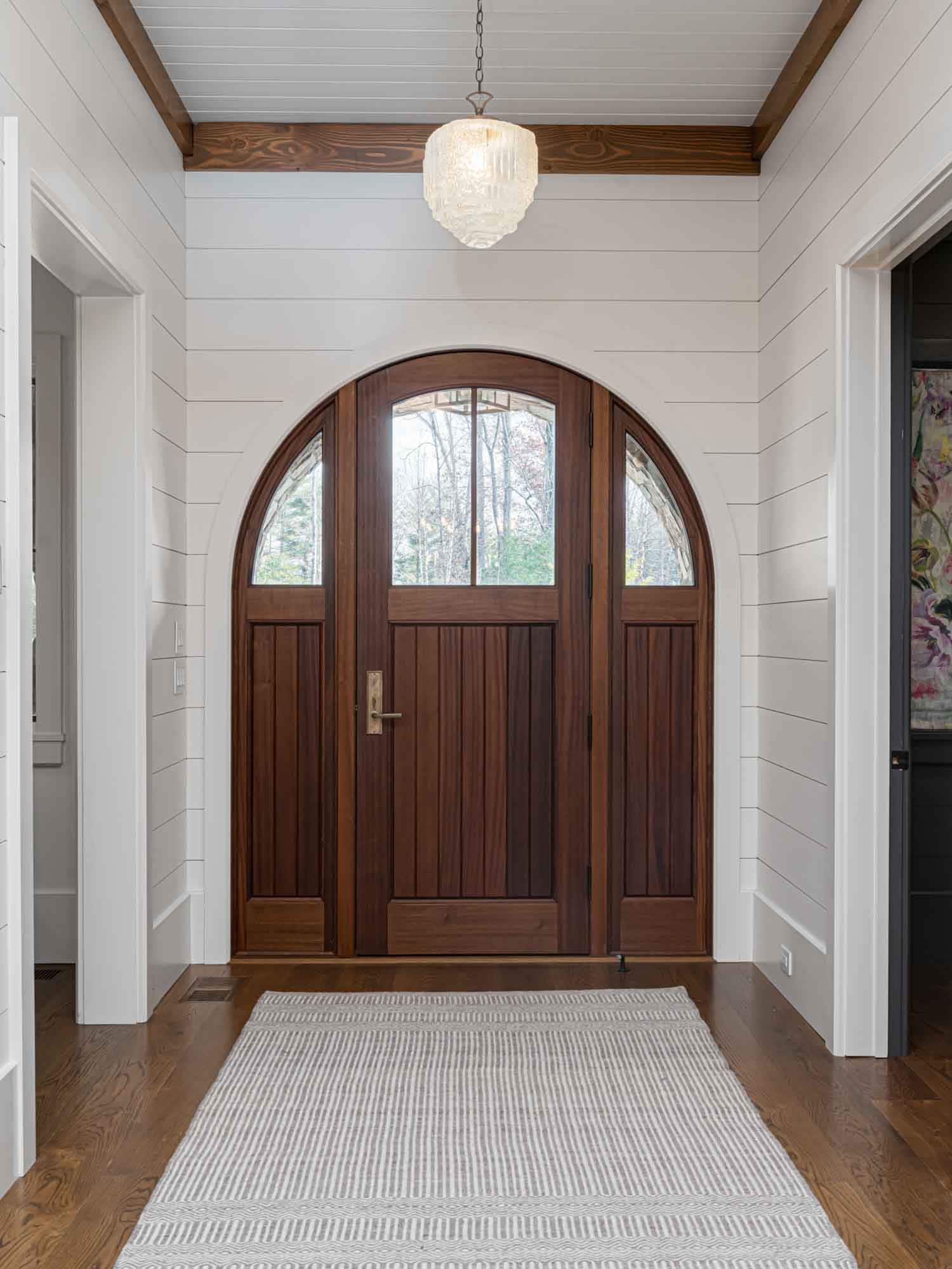 contemporary farmhouse style home entry with a curved front door