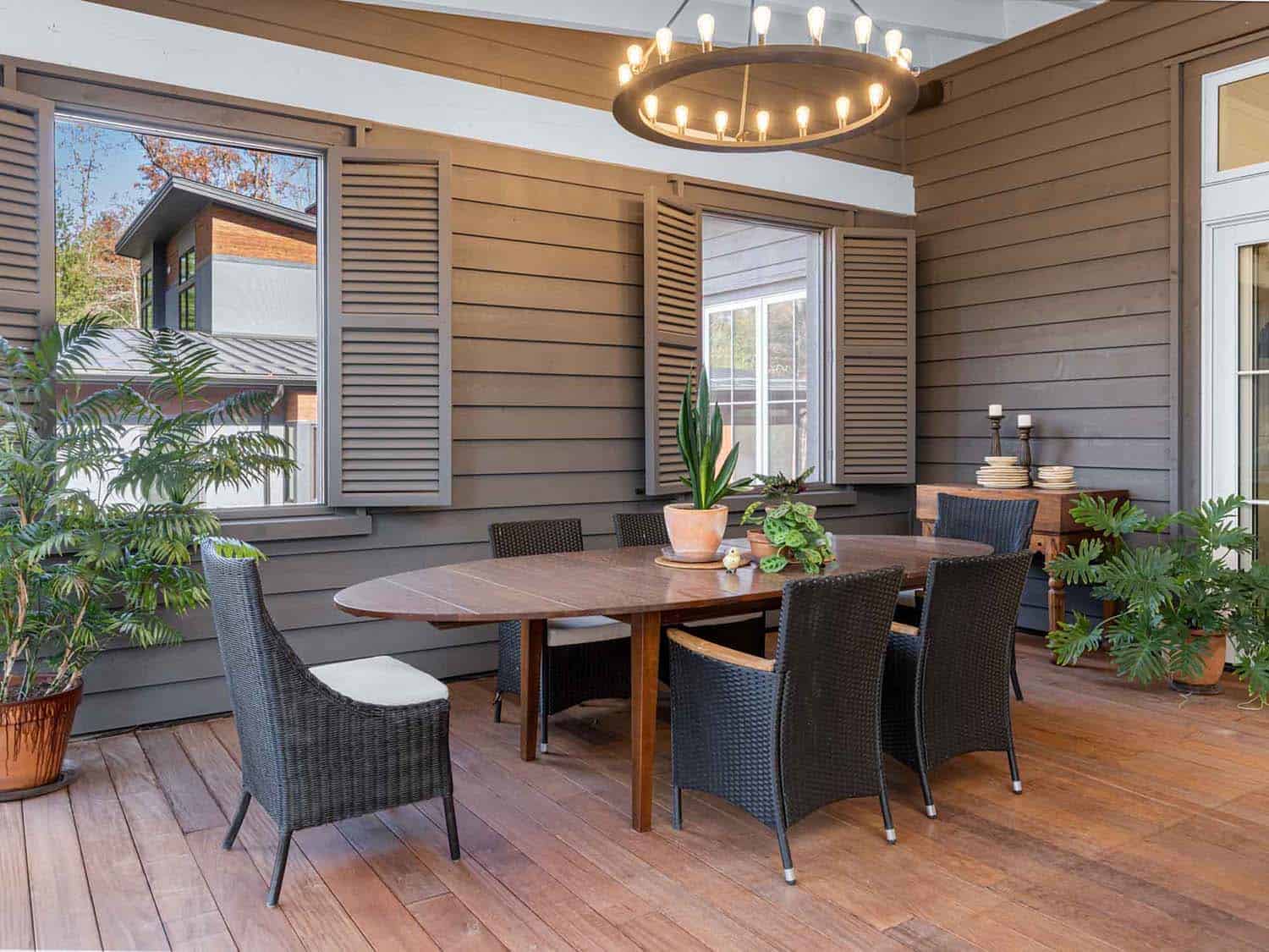 contemporary farmhouse style screened porch with a dining room