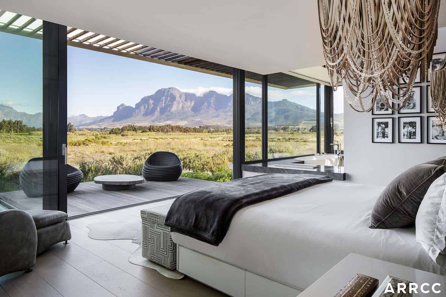 contemporary bedroom with an outdoor terrace and mountain views