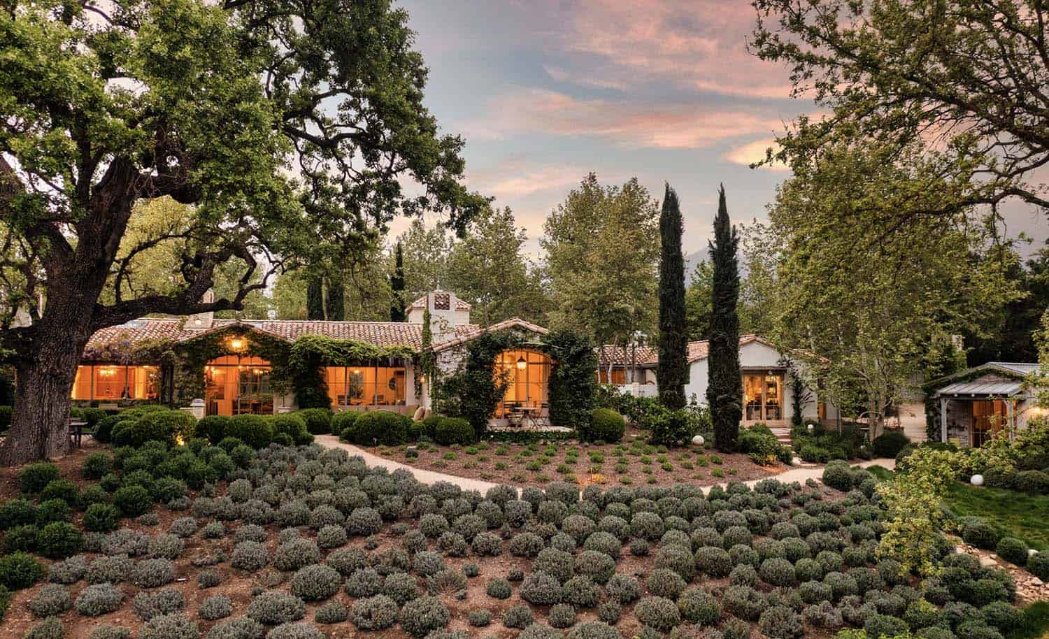 European-inspired country home exterior at dusk
