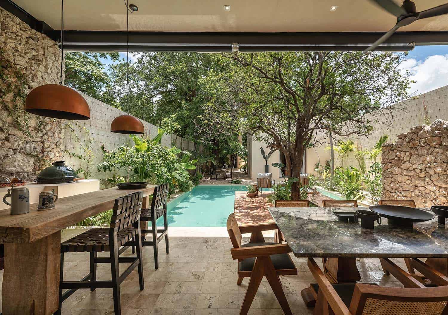 contemporary covered patio with outdoor kitchen and dining area