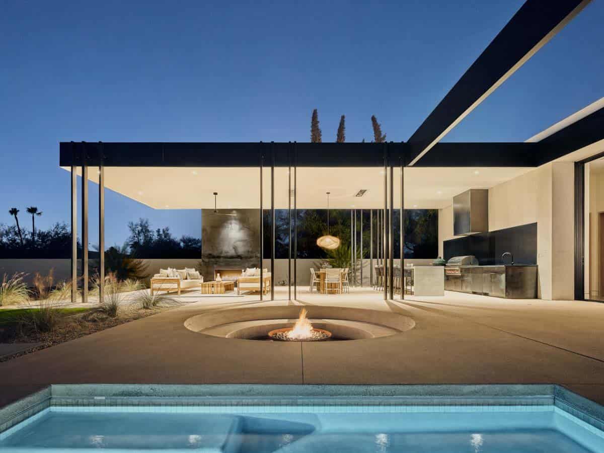 modern desert house exterior patio and pool at dusk