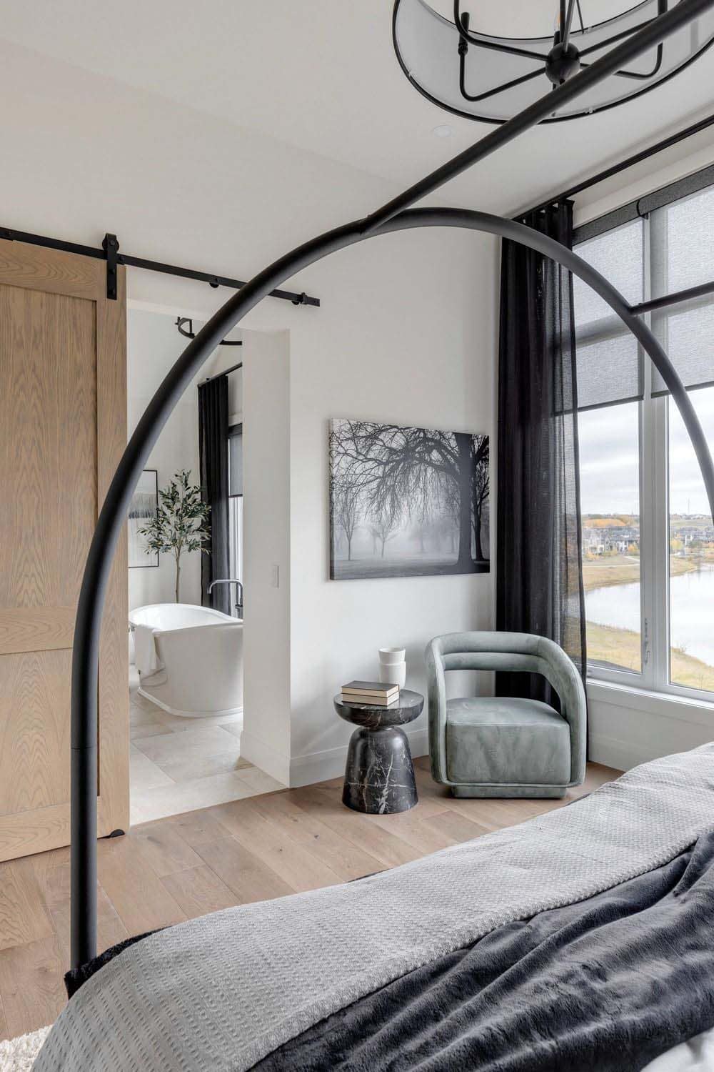 contemporary bedroom with a sliding door leading into the bathroom