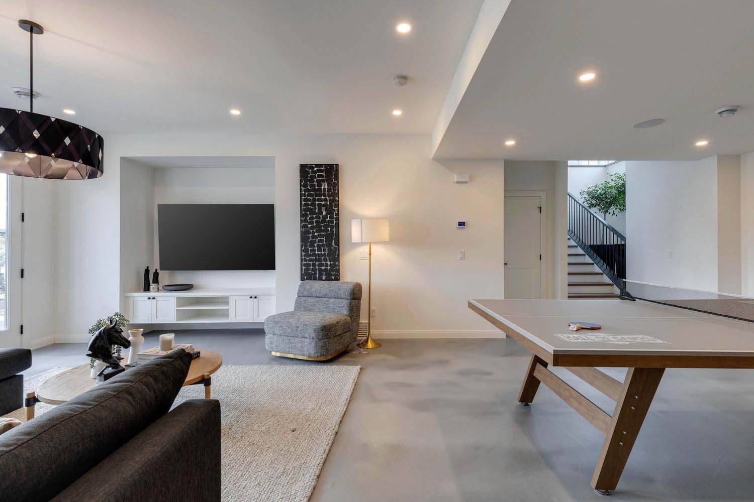 contemporary lower level family room with a ping pong table