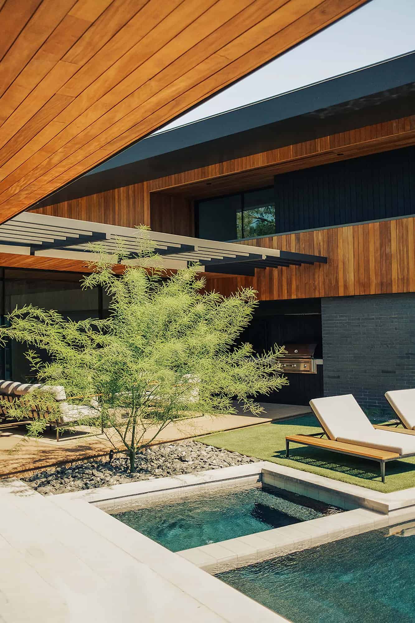mid-century modern home exterior with a pool
