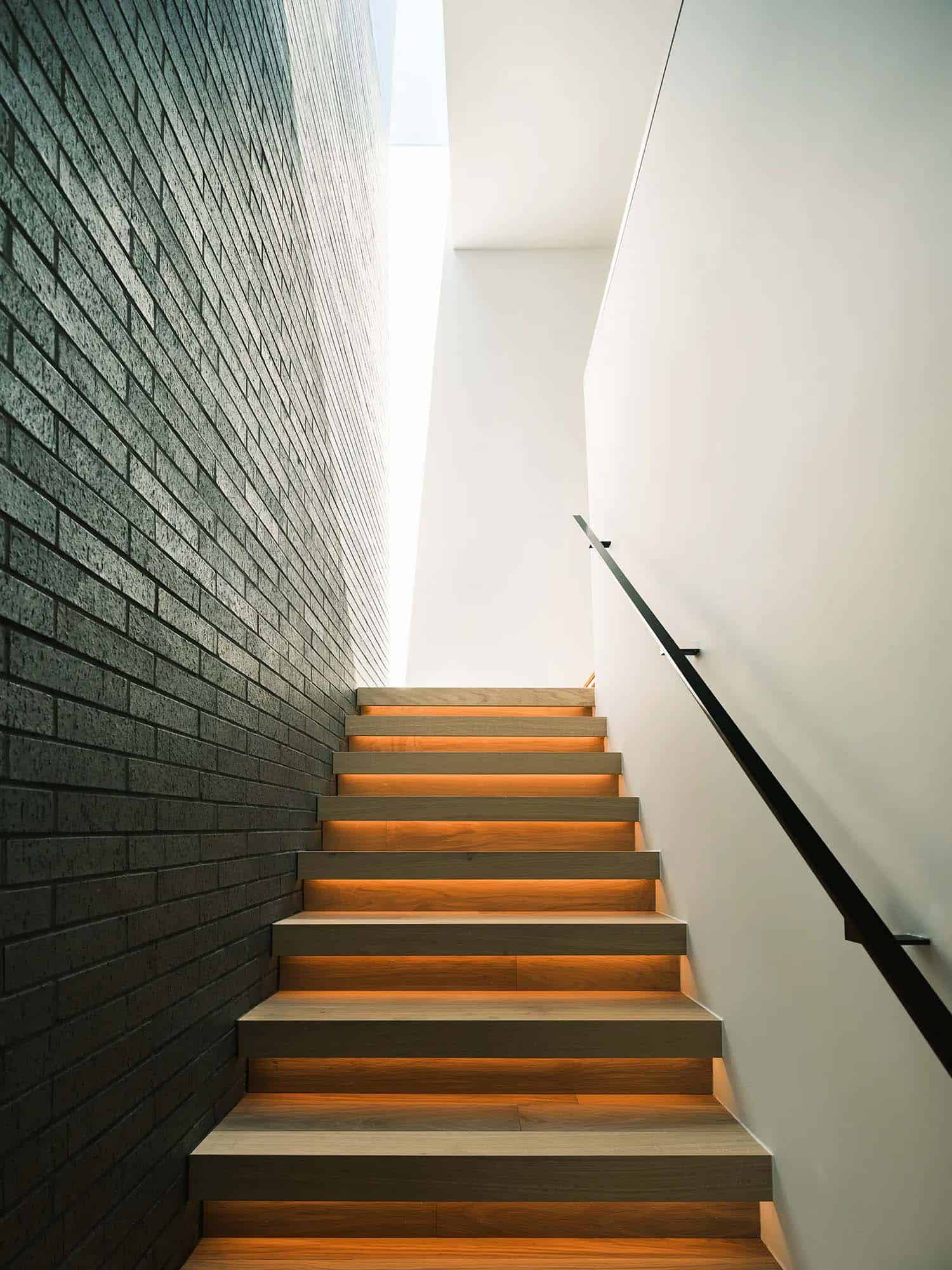 mid-century modern staircase with a metal railing and wood tread