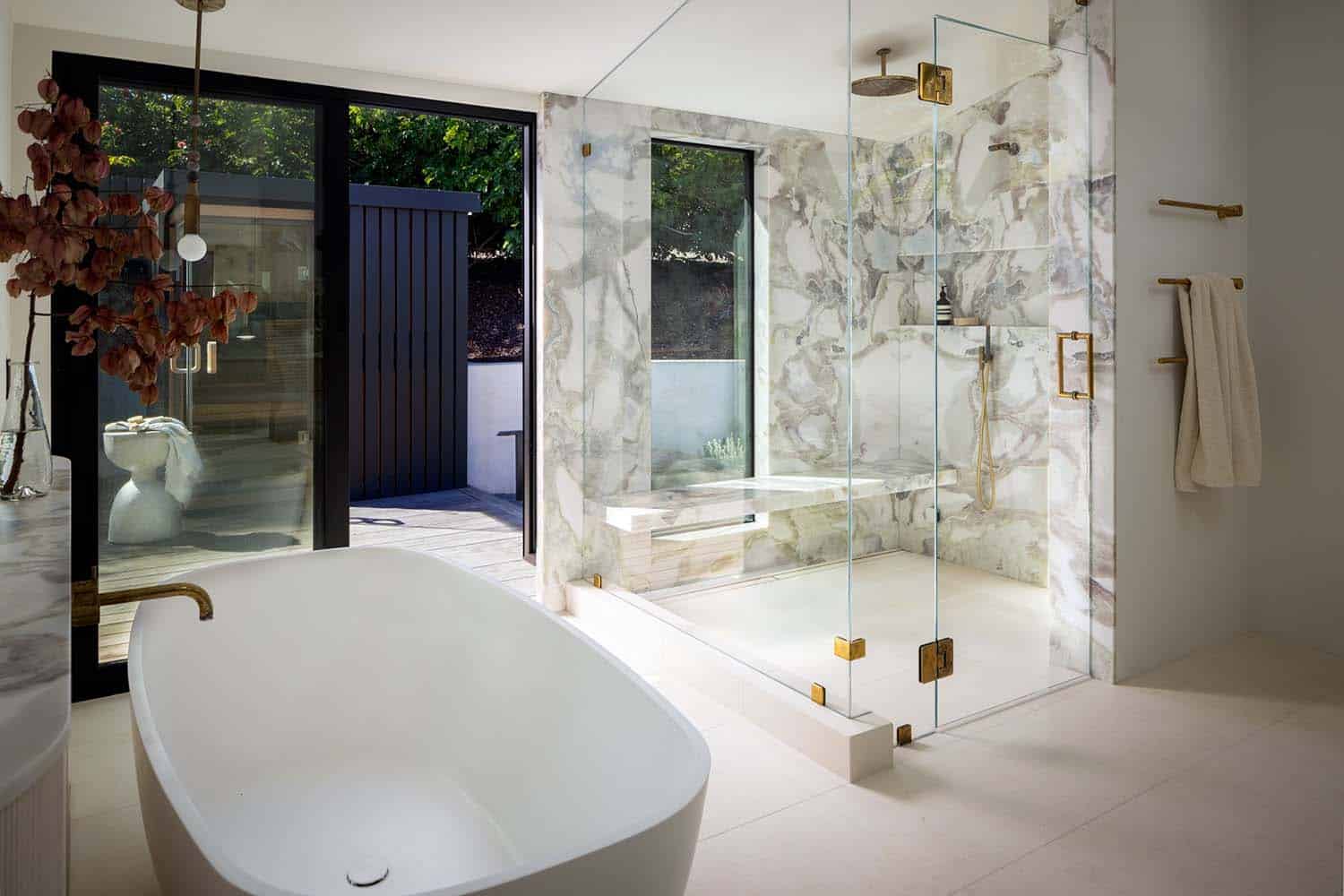 midcentury modern bathroom with a freestanding tub and marble shower
