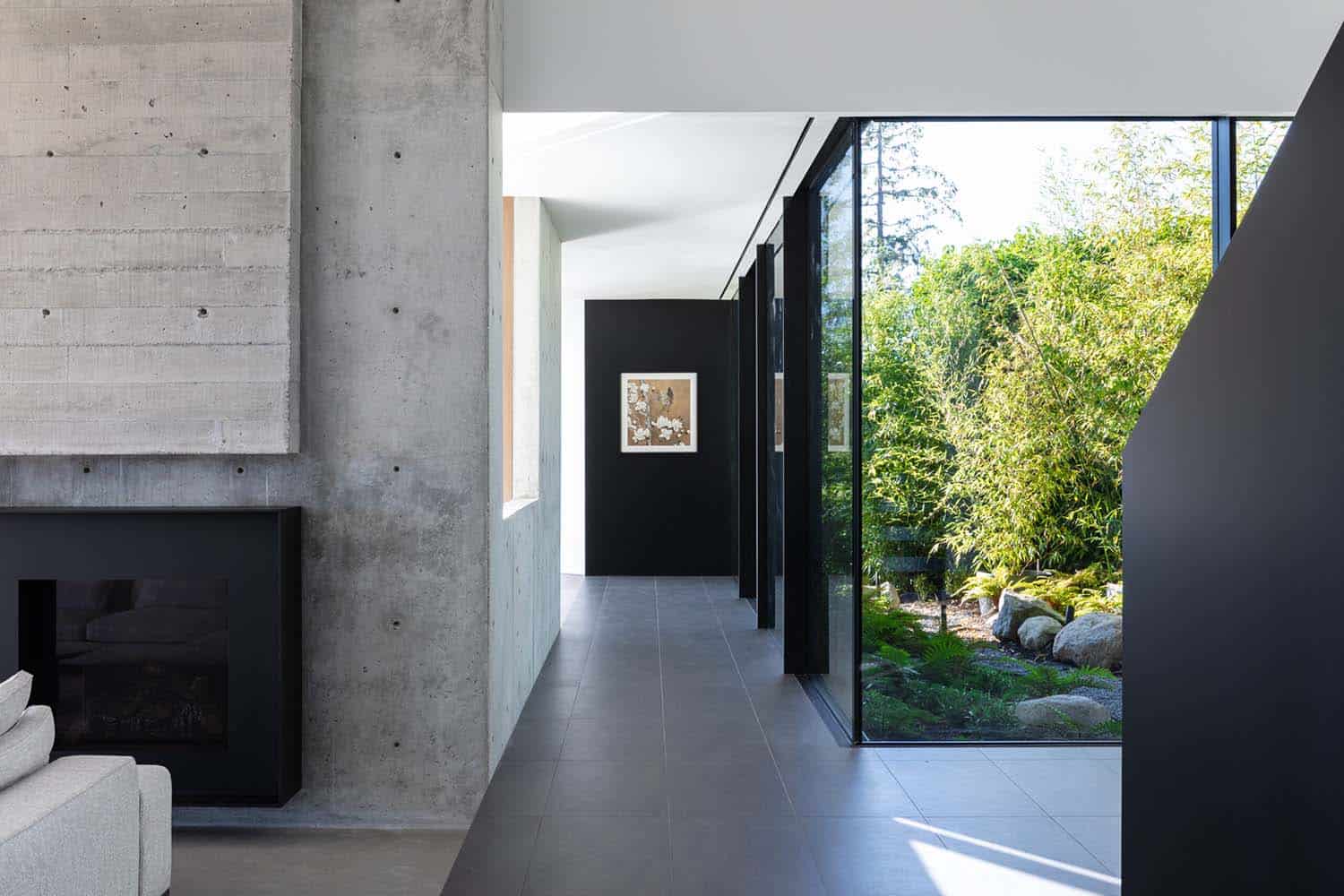modern hallway with glass walls looking out to nature