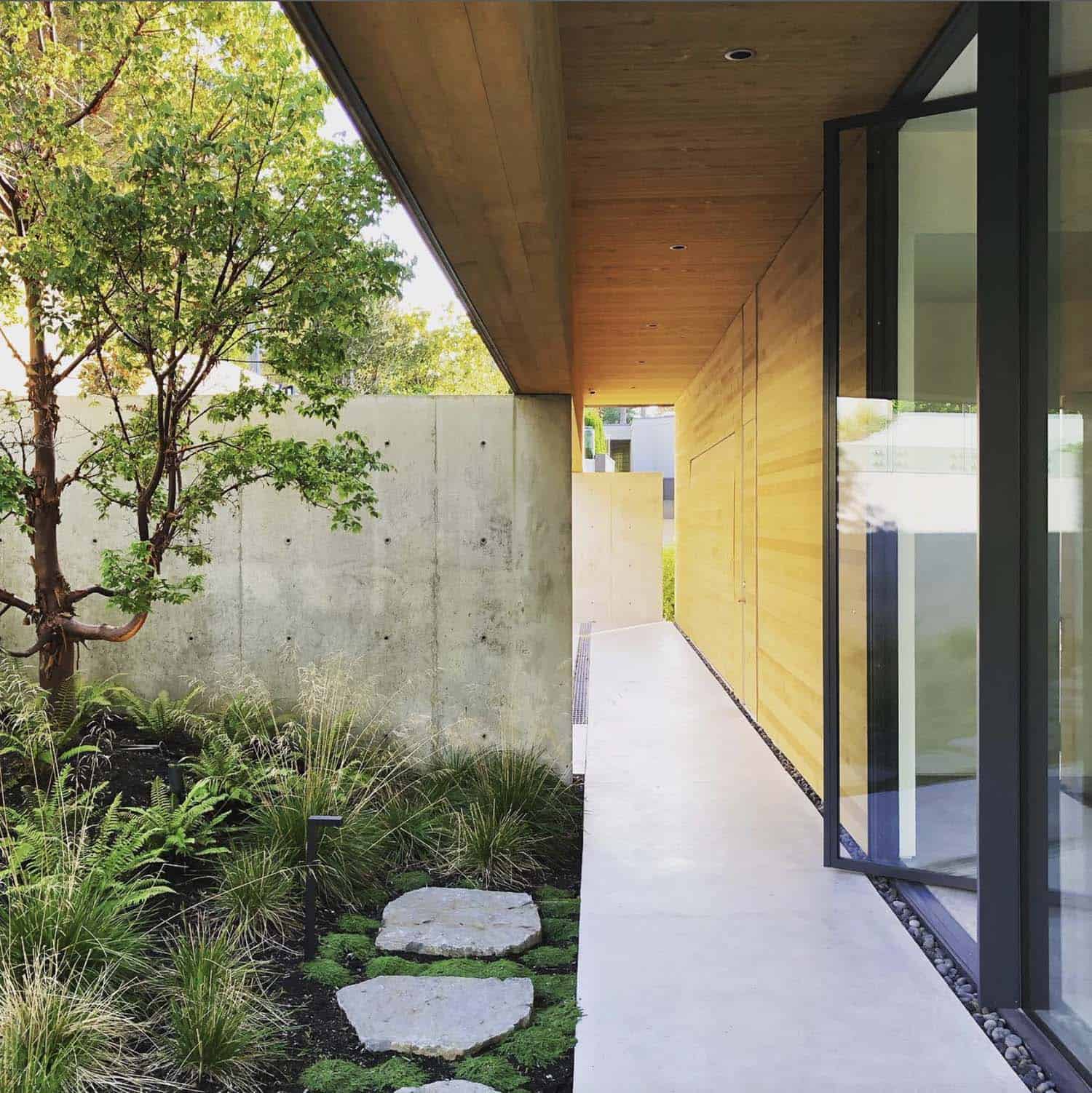 minimalist home exterior with a paver pathway