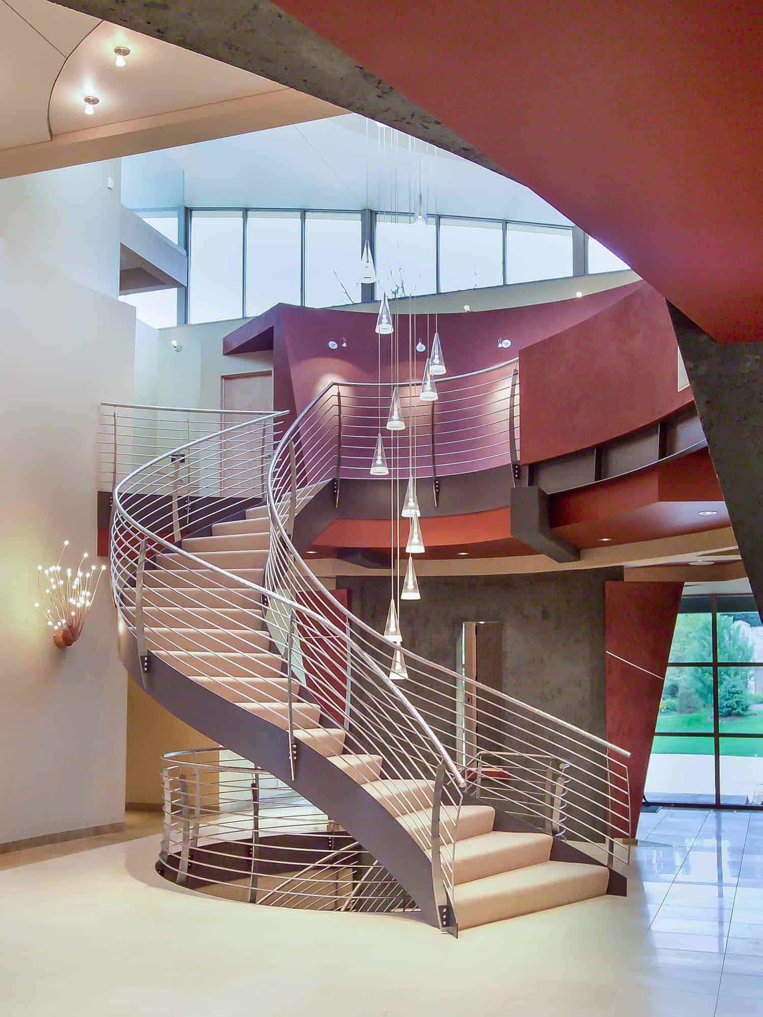 modern home entry with a curved staircase