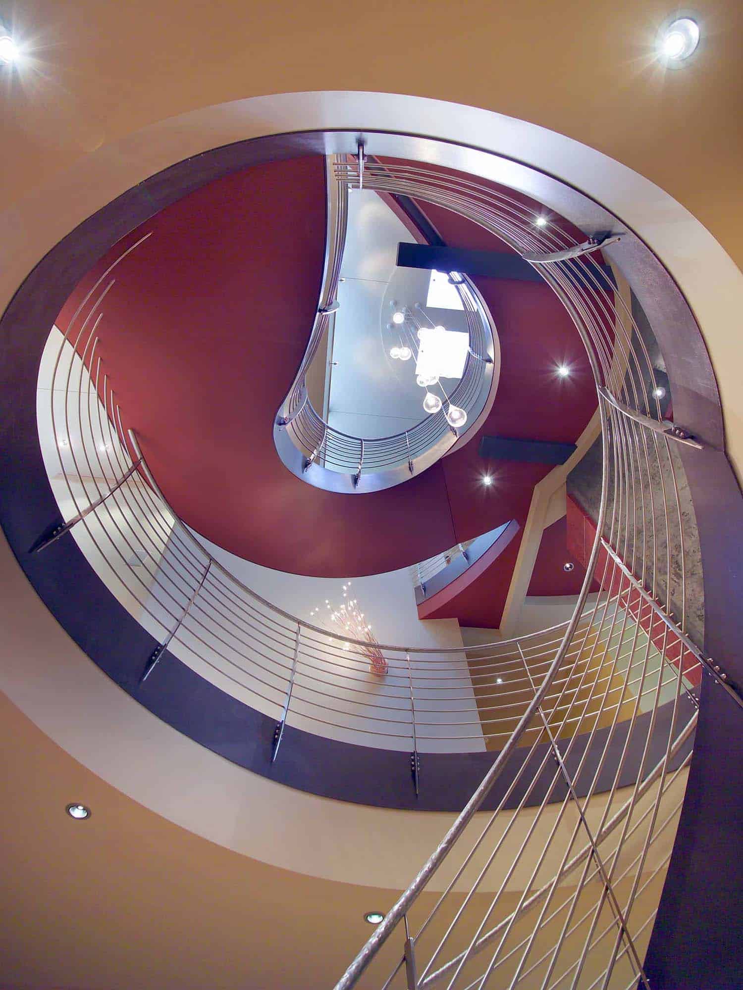modern curved staircase looking upwards to the second level