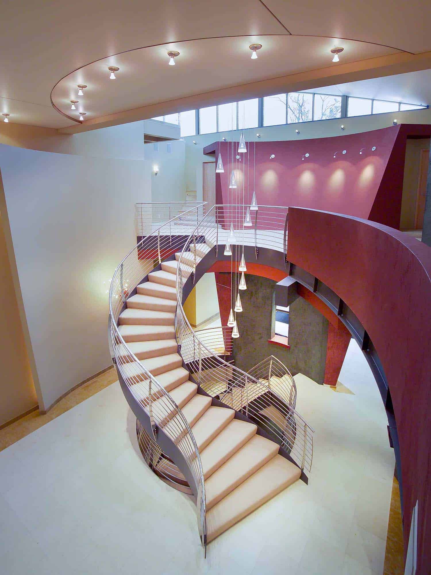modern curved staircase view from the second level