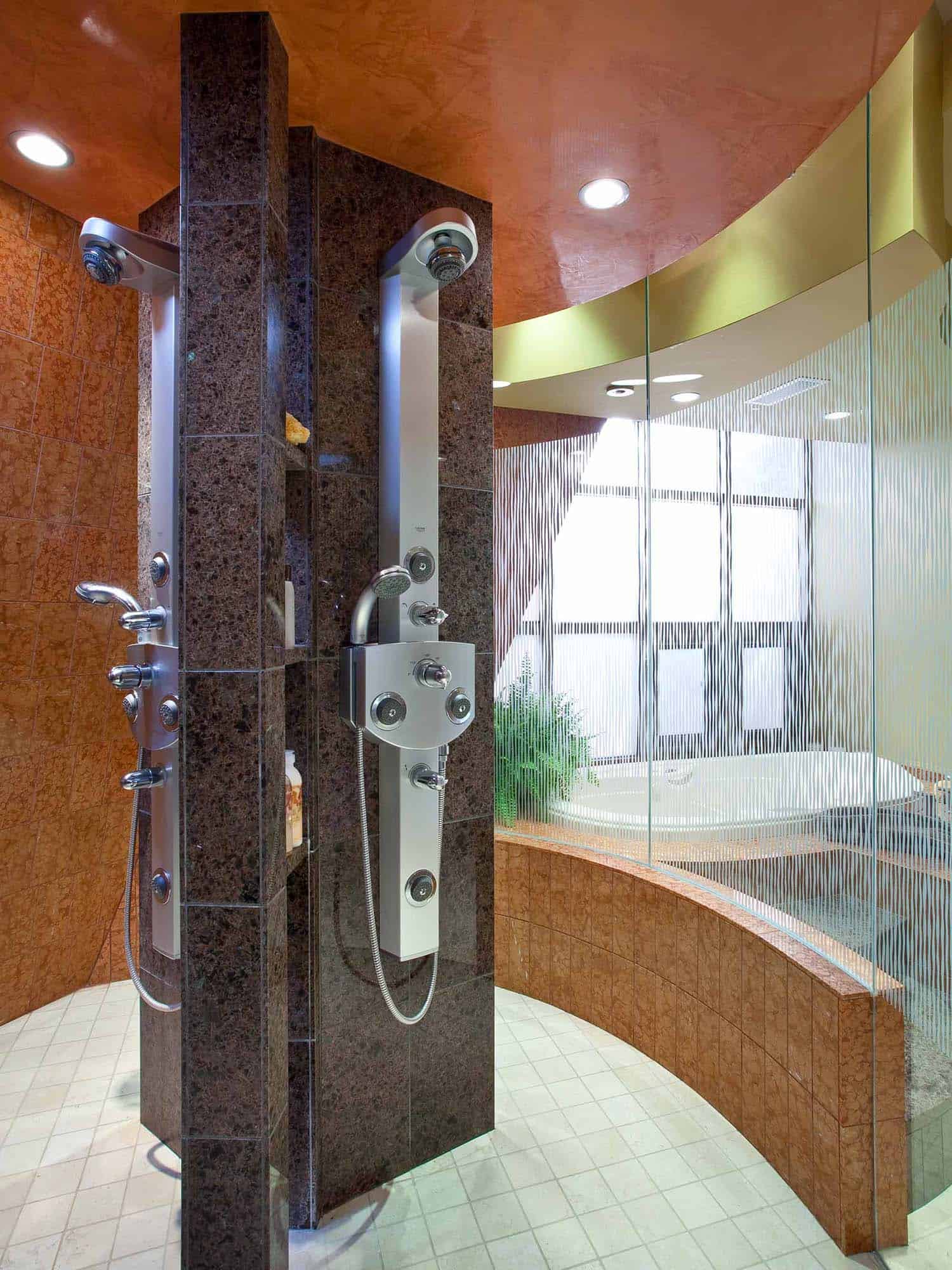 modern bathroom glass-enclosed shower interior view with spa shower heads