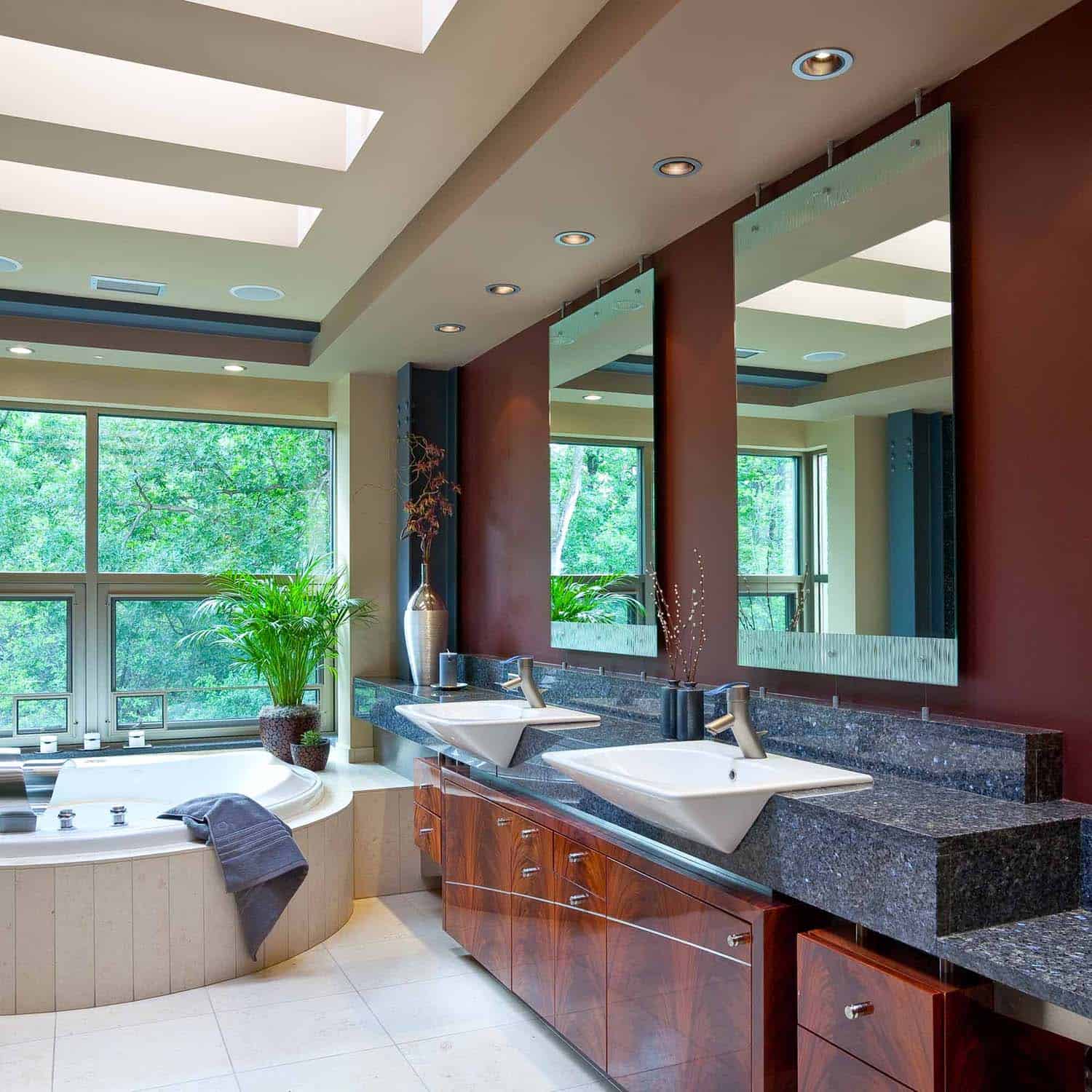 modern bathroom with a vanity, skylights and integrated spa tub