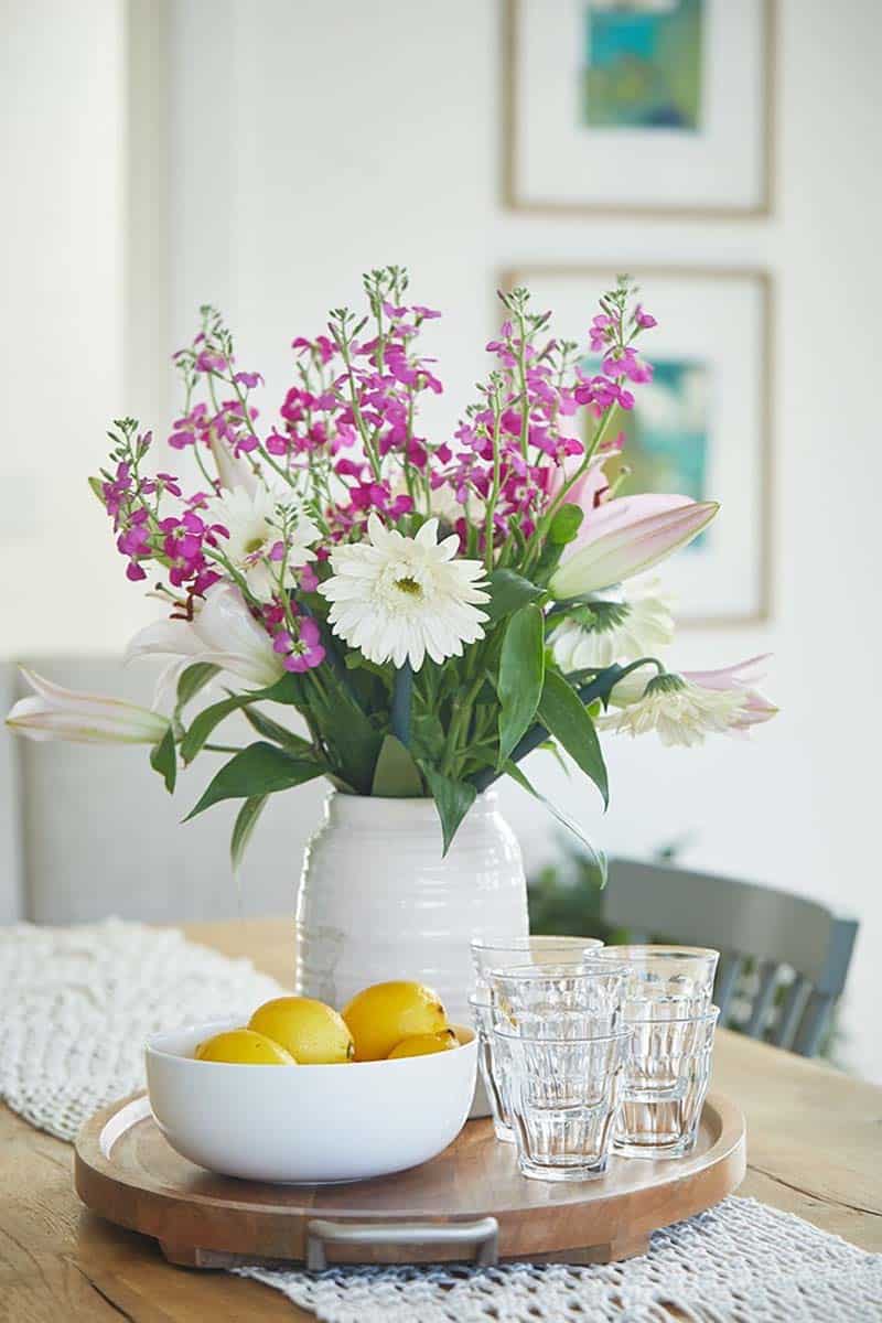 modern farmhouse dining room table with a vase of flowers