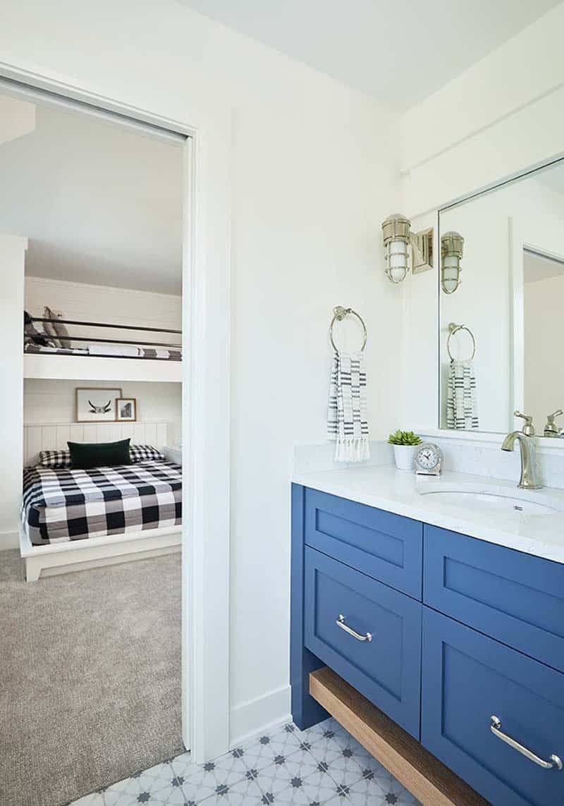 modern farmhouse bathroom with blue cabinets looking into the boys bunk bedroom