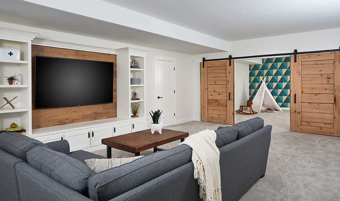 modern farmhouse family room with a sliding boor door leading into the playroom