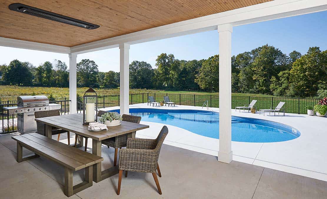 modern farmhouse backyard covered patio with alfresco dining overlooking the pool