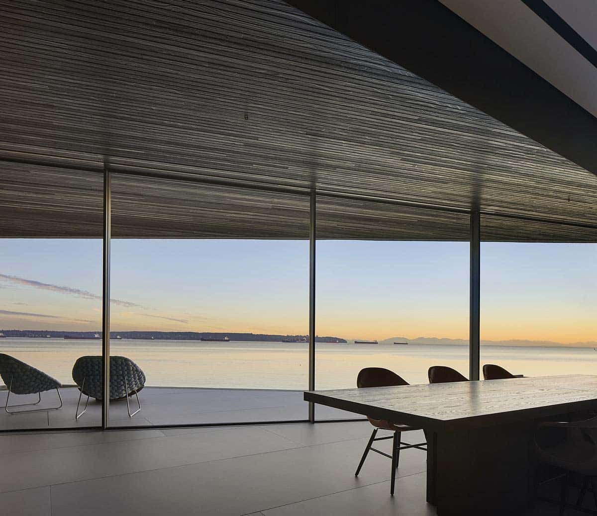 modern kitchen with walls of glass and a view of the ocean