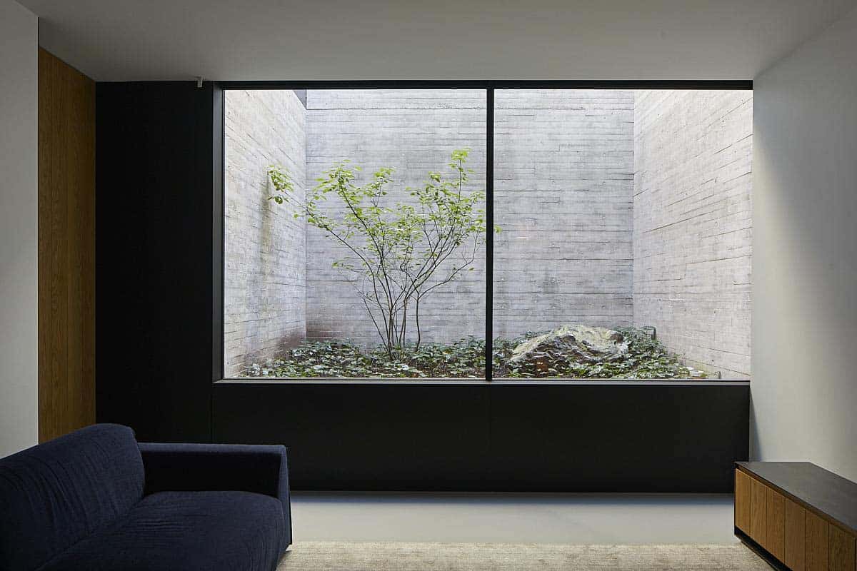 modern family room with a window view into an interior courtyard